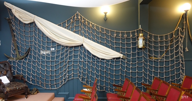 Cargo net spread wide along a wall