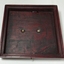 Lid has fitted edges and brass fixtures in centre