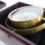 Compass base within box, lid beside box. Compass is tilted on its gimbal.