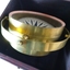 Compass is tilted in its base, resting on its gimval ring