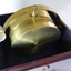 Side view of brass compass and gimbal within box