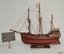 Handwritten sign beside model of a sailing ship