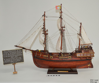Handwritten sign beside model of a sailing ship