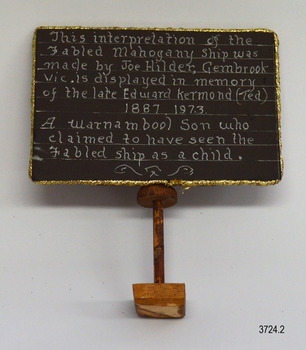 Handwritten text on vertical board describing model
