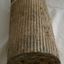 Cylinder shape ammunition shell with flat base and pointed tip. Vertical channels are around the side.