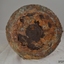 Round base is corroded and metal has flaked away