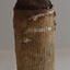 Tip is conical. Base has white wear marks and ribbed sides