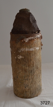 Tip is conical. Base has white wear marks and ribbed sides