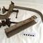 Metal rocket launcher's bracket, cradle and fittings, painted grey, with some corrosion