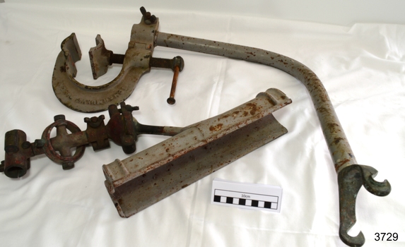 Metal rocket launcher's bracket, cradle and fittings, painted grey, with some corrosion