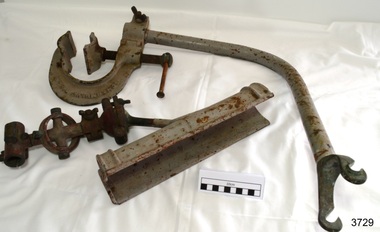 Metal rocket launcher's bracket, cradle and fittings, painted grey, with some corrosion