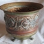 Copper tooled design on pot also seen on the inside of the pot, in reverse