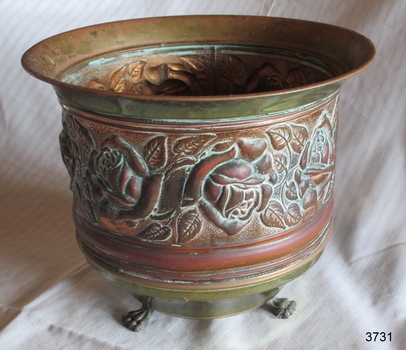 Copper tooled design on pot also seen on the inside of the pot, in reverse