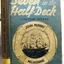 Book's cover has pasted on coloured page with a sailing ship within a lovebuoy