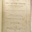 Fly page has black print, handwritten inscriptions and a stamp