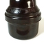 A small bottle of ink, sitting in a brown Bakelite screw top container, designed to protect it during travel.