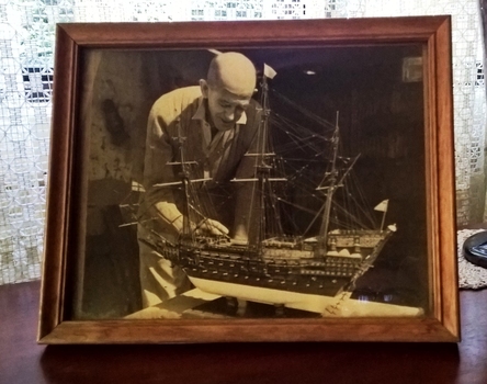Photograph of maker Jim Williams working on the model
