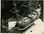 Semigloss sepia photograph of the model ship from a birds-eye view. 
