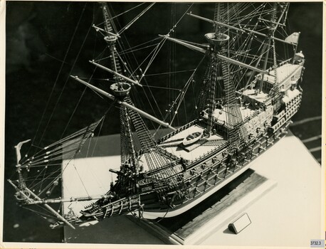 Semigloss sepia photograph of the model ship from a birds-eye view. 