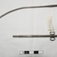Stainless steel catheter with scissors like handles at one end of the curved instrument and an opening in the tube at the other end.