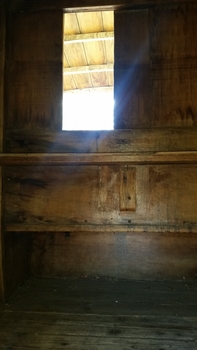 An opening inside the covered cart allows for goods to be passed through