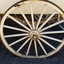 The large wheels have sixteen spokes. Below the body are leaved springs for suspension.