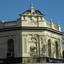 The sandstone building has intricate moulding, one representing a wheat sheaf