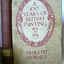 Purple hardcover book. Front has a pasted on jacket cover with oval design. Spine has a label.
