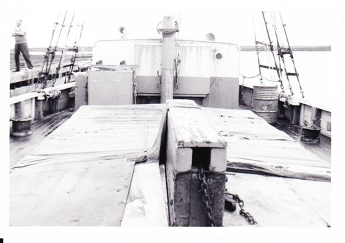 Photograph, black and white, deck of REGINALD M with figure on board