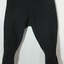 Dark fabric pants with silk waistband, tapered legs with buttons on the outer leg
