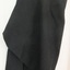 Front of dark fabric skirt has a cross-over flap