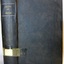 Black cloth hardcover book with embossed gold print on the spine
