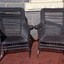 Front of two upright wicker chairs painted black