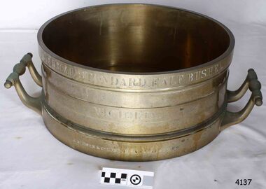 Brass cylinder with handles and engraved text