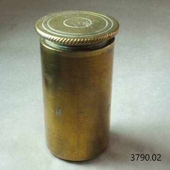 Brass cylinder with decorated top