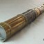 Telescope is shiny brass, in several telescoping sections, with leather hand grip 