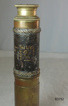 Image is stamped and embossed in gold. It has both text and an image of a bird.
