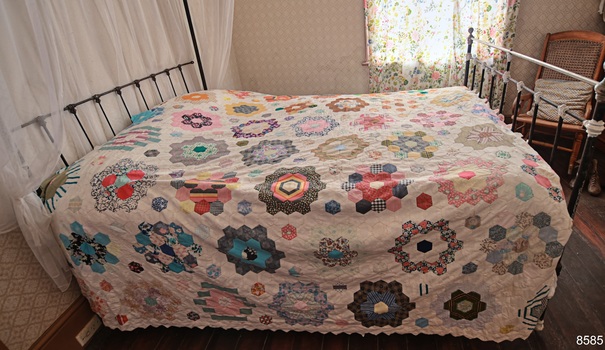 Hundreds of octagonal shapes of colourful patterned fabrics sewn together to create a patchwork quilt