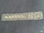 Label is hand stitched onto jacket and has text 'WARRNAMBOOL' embroidered in gold