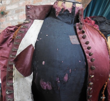 Burgundy pocket is fitted at an angle and placed to fit body contours