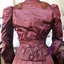 Jacket is fitted close to body and finished at the waist with a ribbon