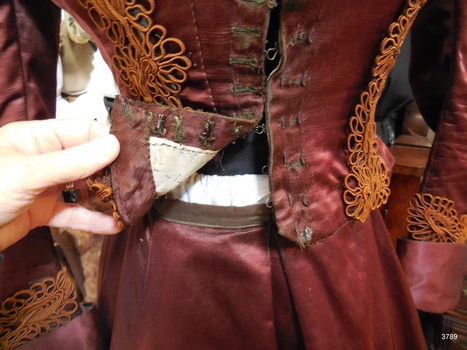 Front of burgundy skirt showing waistband and soft pleat
