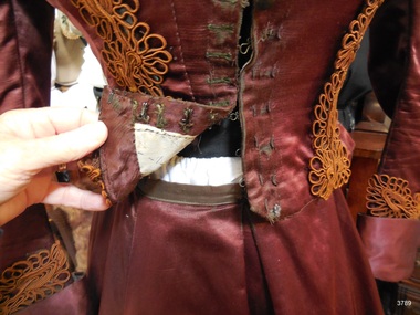 Front of burgundy skirt showing waistband and soft pleat