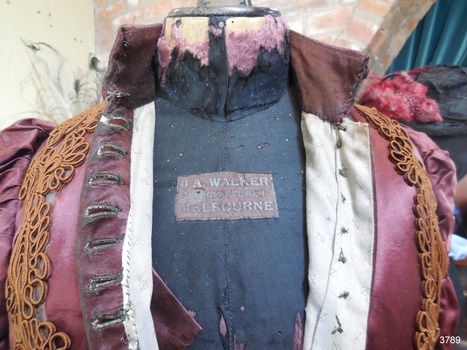 Maker's label is attached to the front chest area of the mannequin