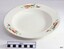 White plate with blue rim and decorated with motifs of a bird of paradise above floral branch