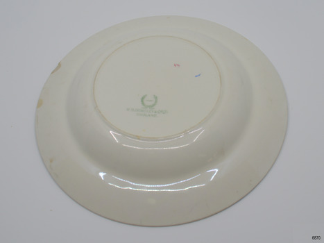 Underside of plate has maker's mark, and other marks. There are some chips and stains.