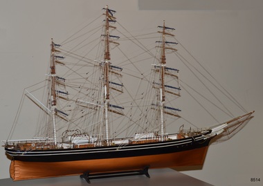 Three-masted ship. White figurehead. Black with white stripes on hull.