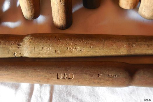 Inscriptions stamped into wood connects pins with Department of Defence