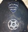 Maker's name on blue, shield-shaped label. Metal five-pointed star-shaped airvent.