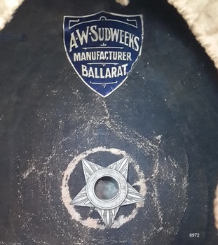 Maker's name on blue, shield-shaped label. Metal five-pointed star-shaped airvent.